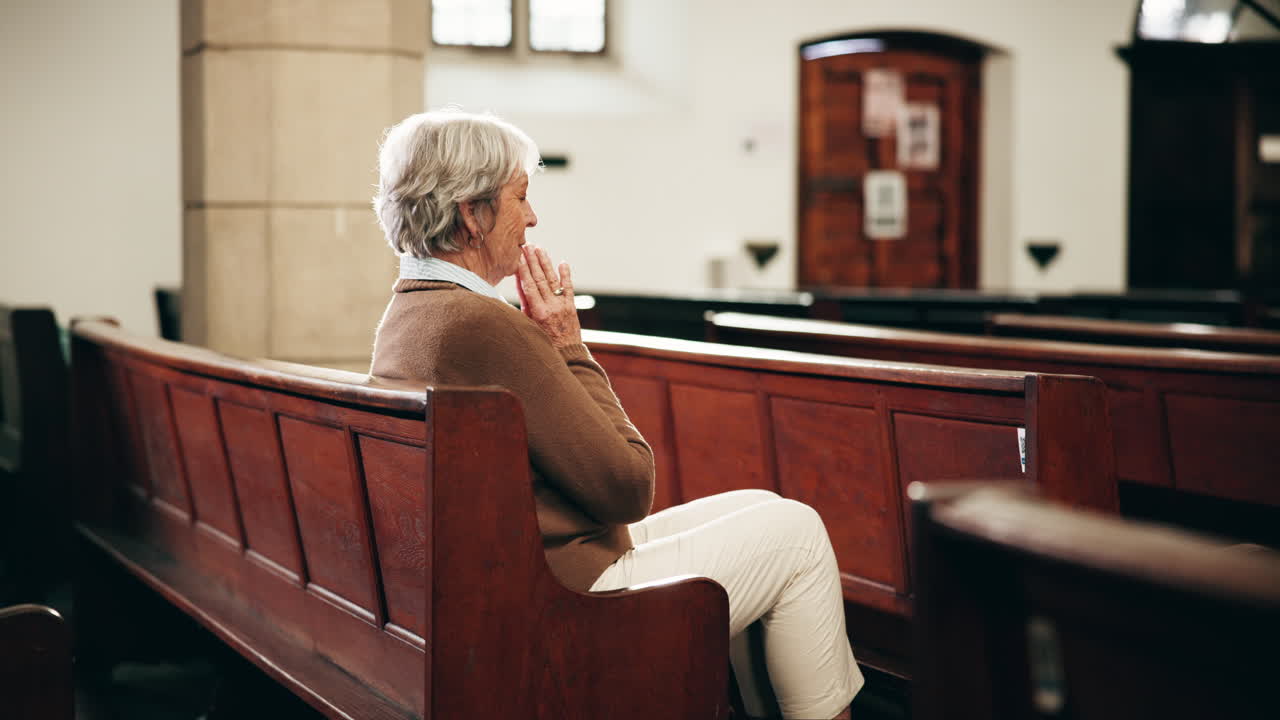 Senior woman praying in church