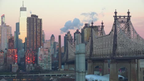 beautiful shot of manhattan new york skyline with queensboro bridge and queens foregroun at dusk or dawn