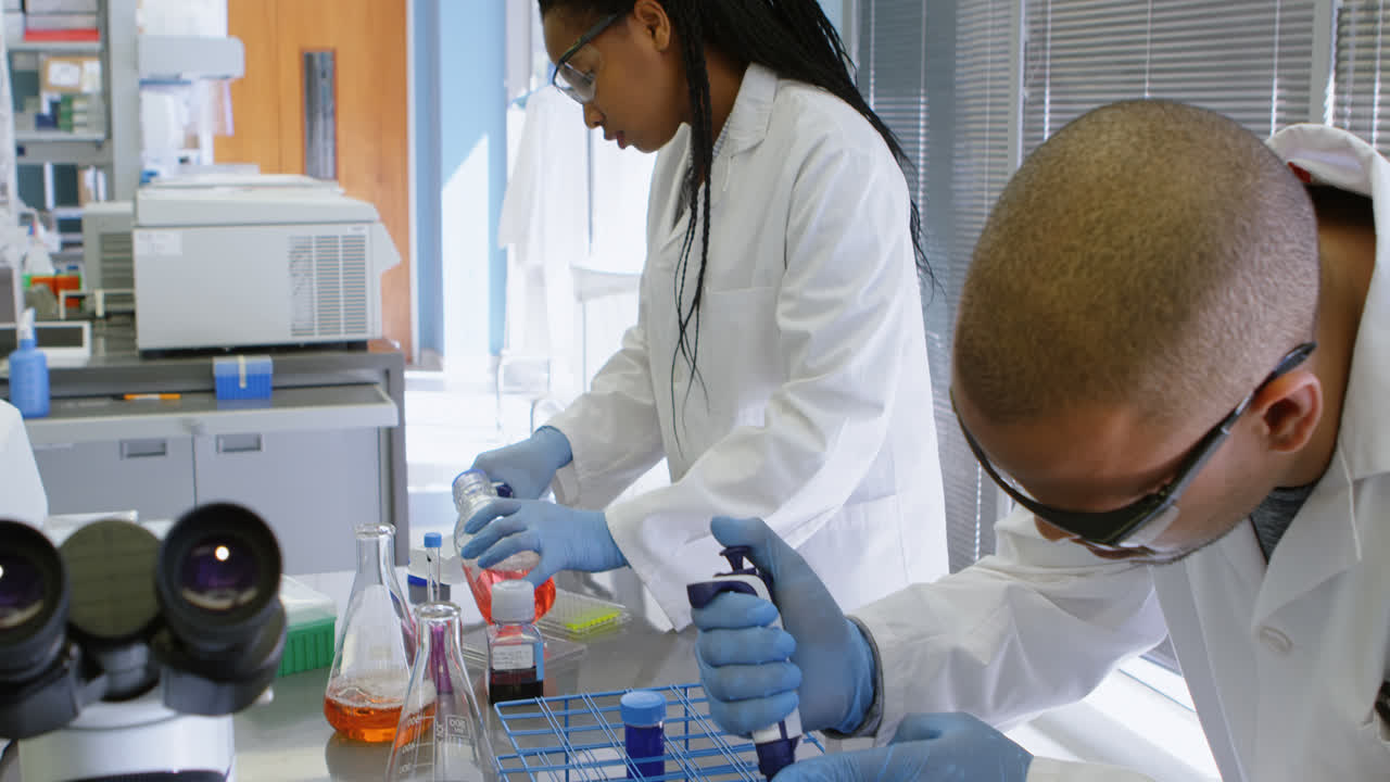 Team of scientists experimenting together 4k