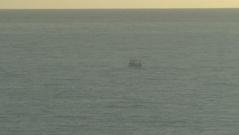 fishing boat going far from the beach