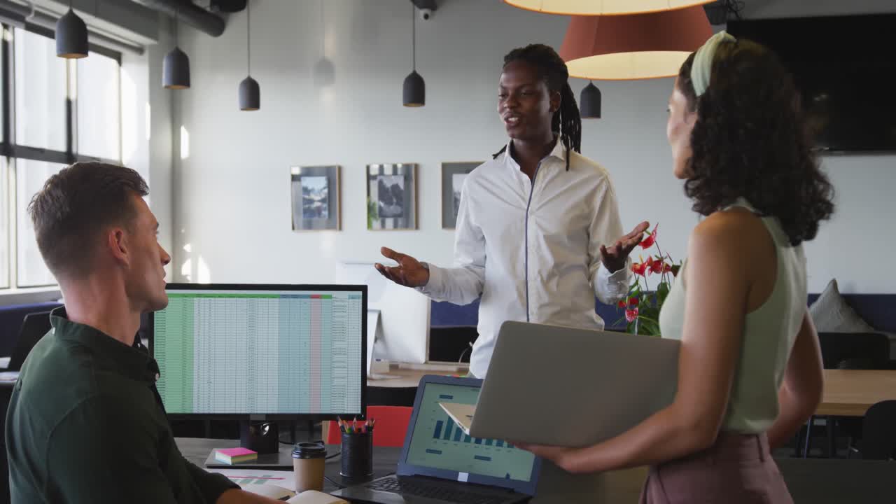 Happy diverse business people discussing work during meeting at office