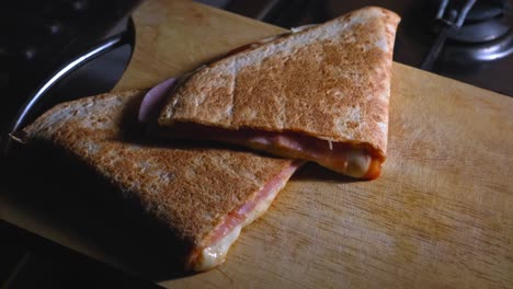 slices of freshly baked pizza tortilla on wooden board