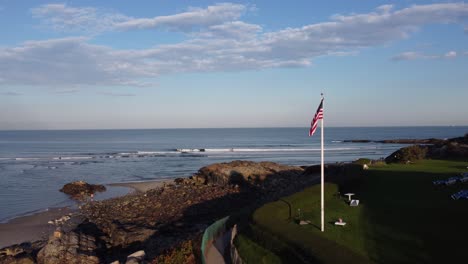 ogunquit maine usa drone fly close to united states flag revealing scenic seascape coastline during sunny day