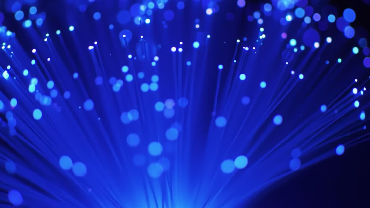 Bright blue lights illuminate the space, creating a mesmerizing display of patterns and colors against a dark background. The dynamic movement adds depth and intrigue to the atmosphere.