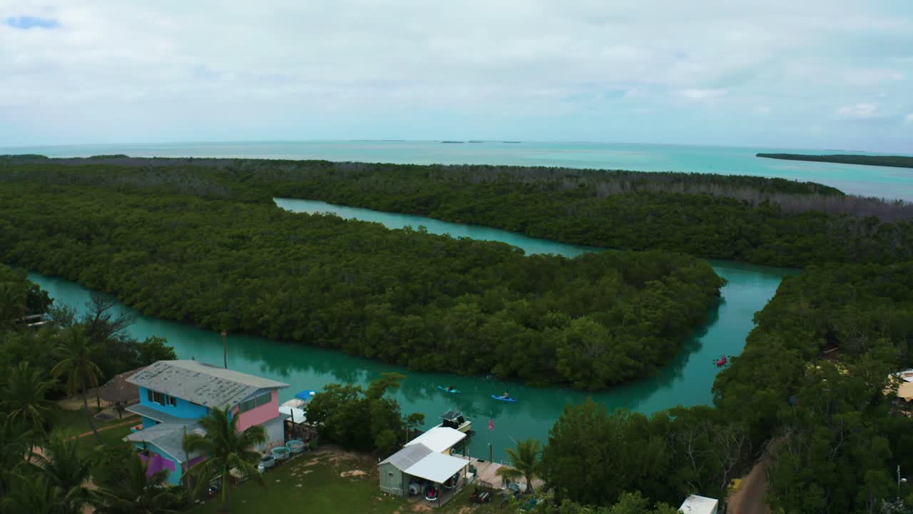 Aerial 4K UHD drone footage of kayaks paddling through the mangroves next to the famous Highway One leading from Miami Beach all the way down to Key West in Florida