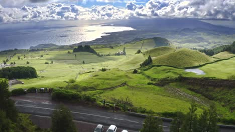 Roadside-lookout-with-view-of-green-hill-countryside,-panoramic-aerial