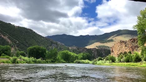 scenery on the big hole river in montana. shot from a raft on the river going under a bridge