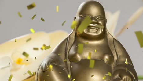 Animation-of-gold-confetti-falling-over-gold-buddha-statue