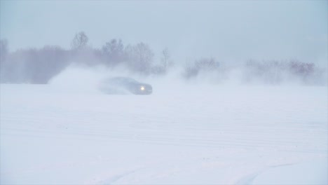 car drifting in a snowy landscape