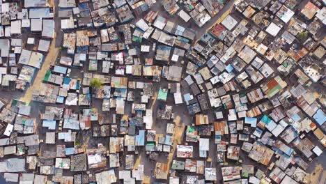 Straight-down-lowering-high-vista-aérea-above-ramshackle-township-of-Gugulethu-one-of-the-poverty-stricken-slums-ghetto-or-townships-of-South-Africa