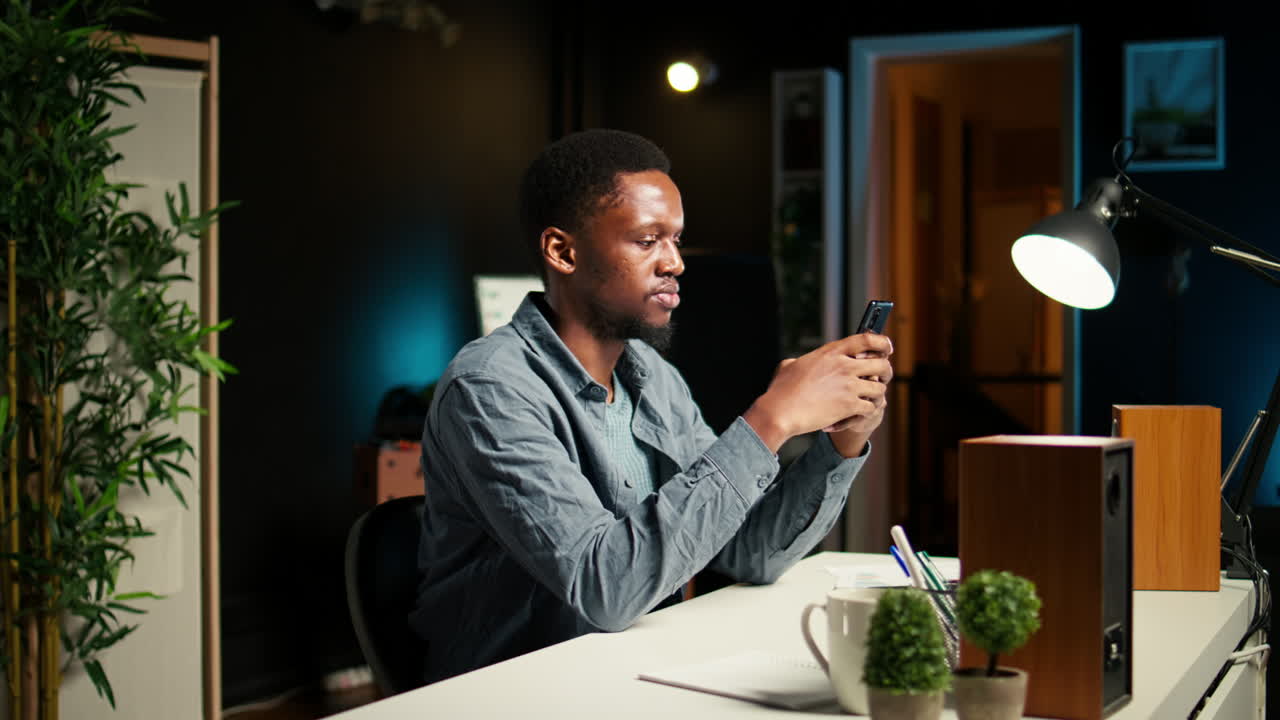 Independent adult teleworking from home and using his mobile phone