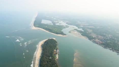 aerial drone shot of an idyllic island village with coconut trees in udupi