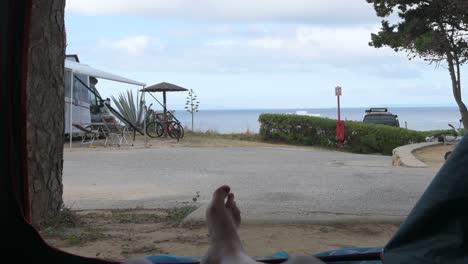 ocean view from inside a camping tent near the coastline