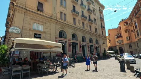 pedestrians stroll through a sunny italian square