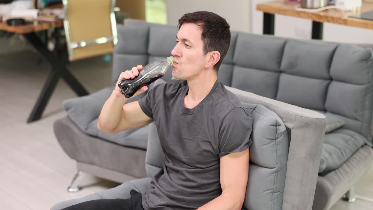 Man Drinking Soda on a Couch