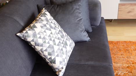 gray sofa with patterned pillows in a modern living room