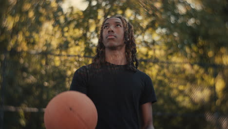 Young Man Playing Basketball Outdoors