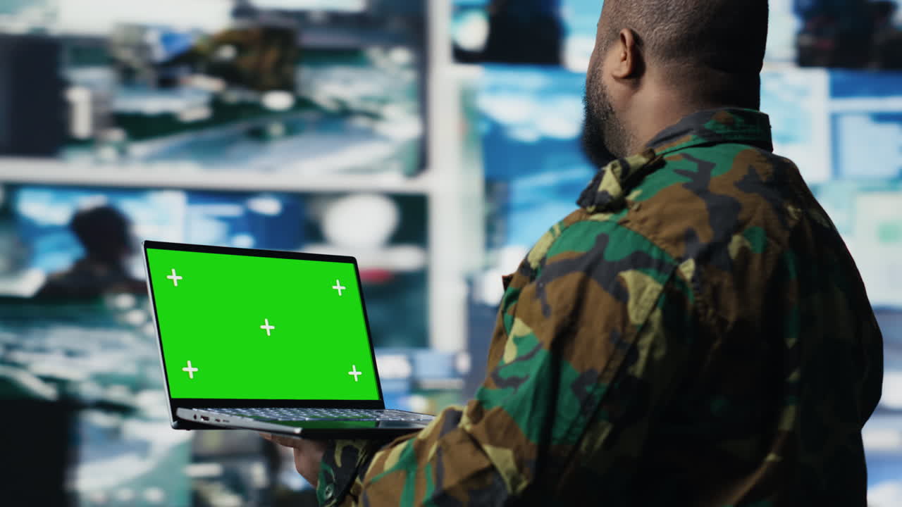 African american trooper holds laptop with copy space screen in a control tower