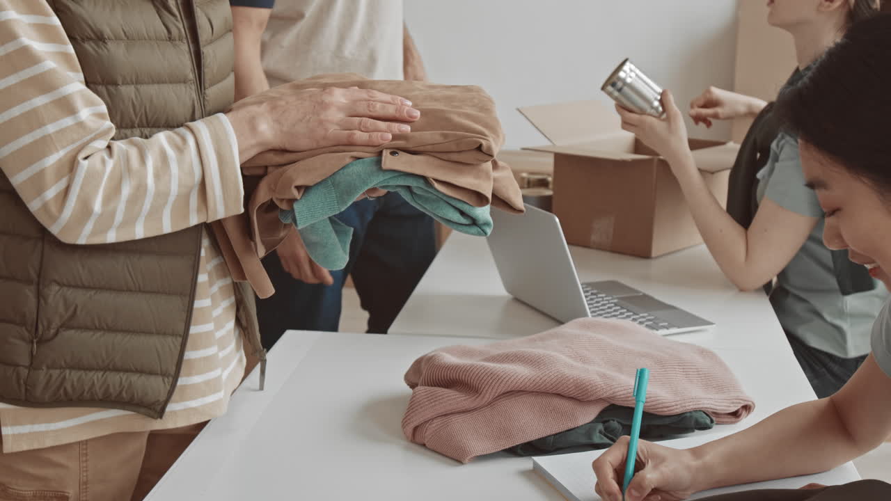 Volunteers sorting clothes and donations for charity