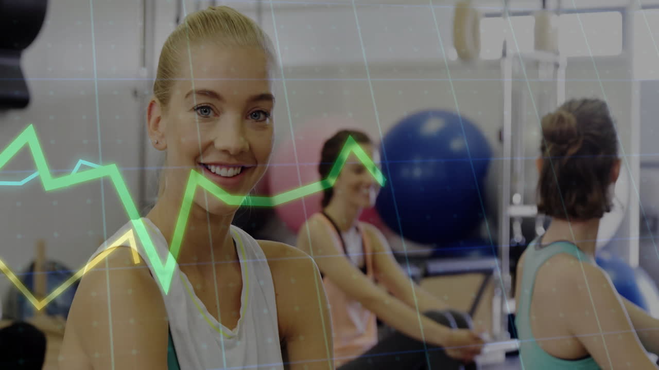 Three women conducting health workout showing animated line graphs and stability balls overlay