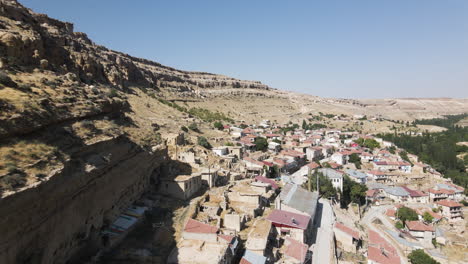 Beautiful-aerial-shot-of-a-unique-village-in-the-mountains-of-Karaman-Turkey-aka-Turkiye-on-a-sunny-day-with-blue-skies