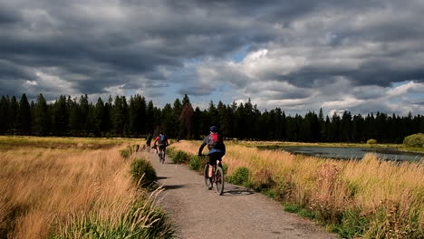 walkers and bikers on a trail along the deschutes river, bend, oregon