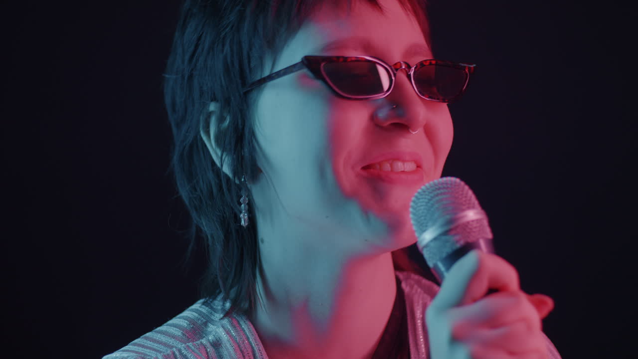 Woman Singing with Microphone in Neon Lights
