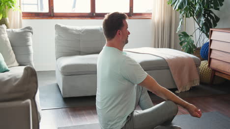 senior man meditating on yoga mat at home, embracing tranquility and peace