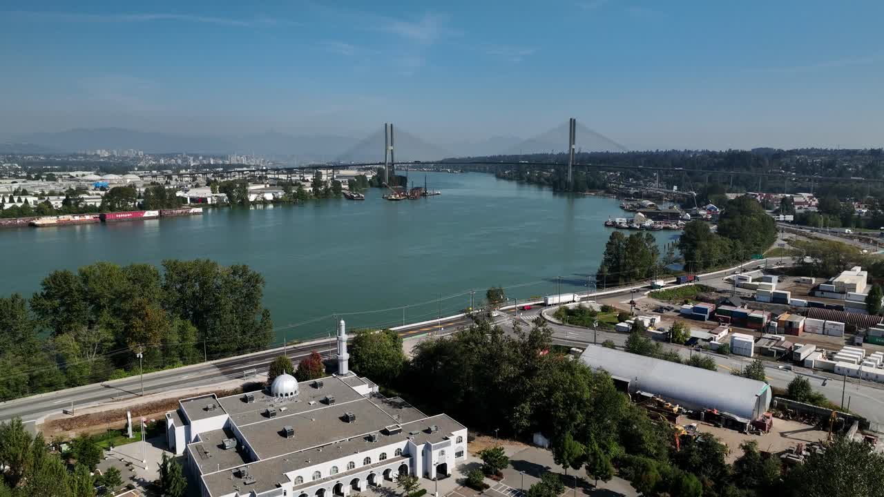 Scenic View Of Fraser River And Waterside Area With Alex Fraser Bridge In Distance At Delta, BC, Canada