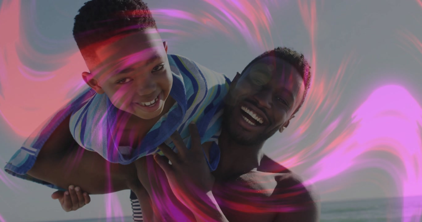 Father carrying son on shoulders at sunny beach laughing while swirling lights enveloping sea