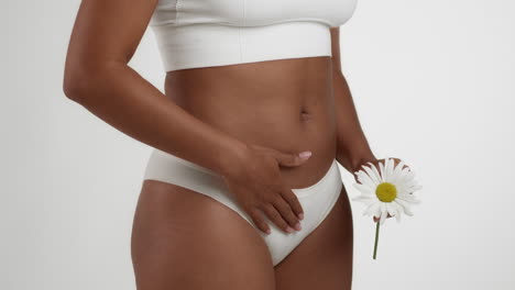 woman with a flower, belly, and underwear