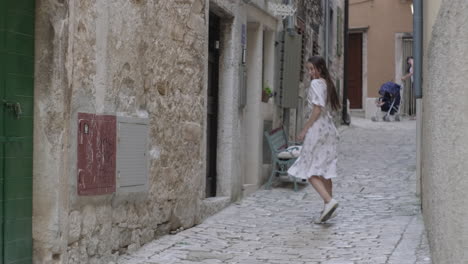 woman walking a charming narrow street