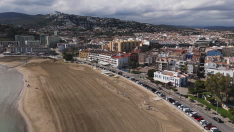 overcast aerial over beach and buildings along the coast of peniscola, spain