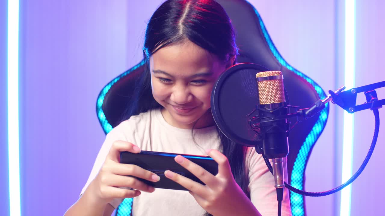 Asian Kid Girl Playing Video Game With Mobile Phone Then Celebrating While Live Stream
