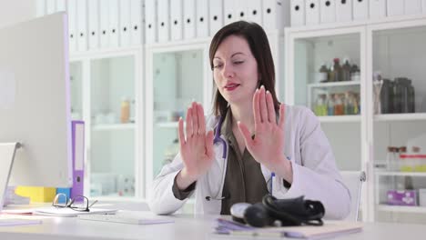 female doctor making a stop or no gesture