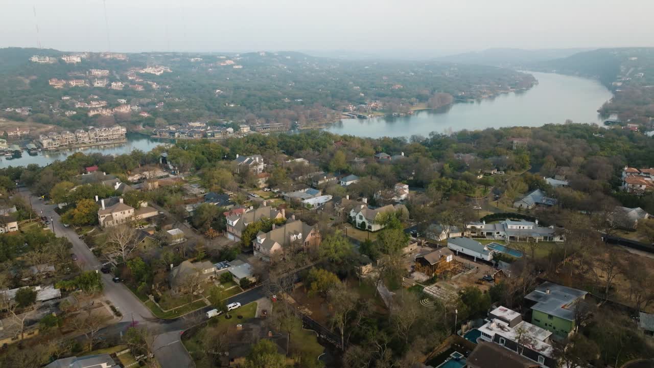 Lake Austin and Suburban Neighborhood Homes in Tarrytown, Austin Texas Aerial tilt up at sunrise in 4k