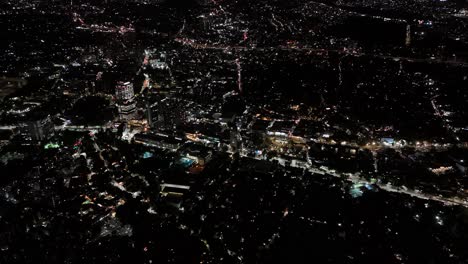 high-level drone view of southern mexico city, illuminated by city lights