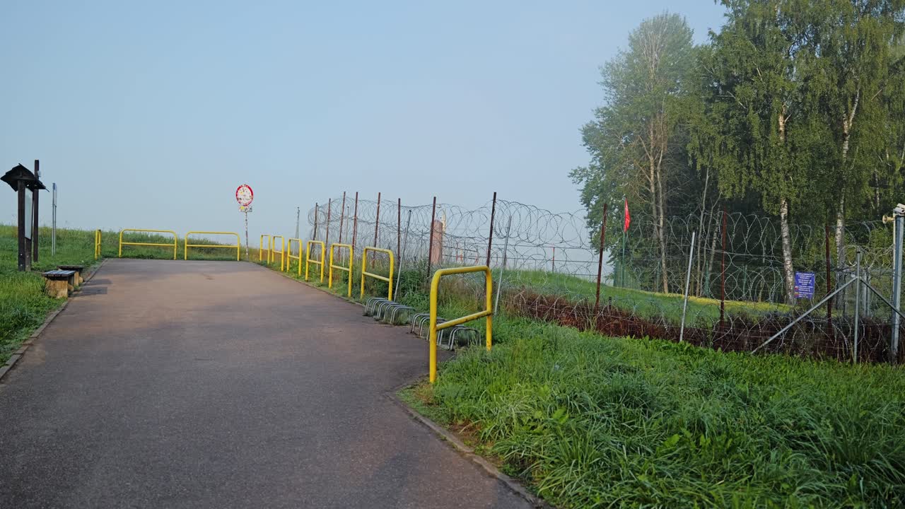Cinematic slow panning view of international border marker and security installation