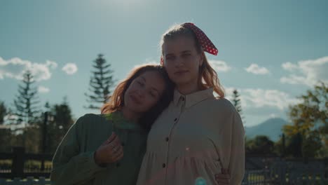 two women friends in a sunny park