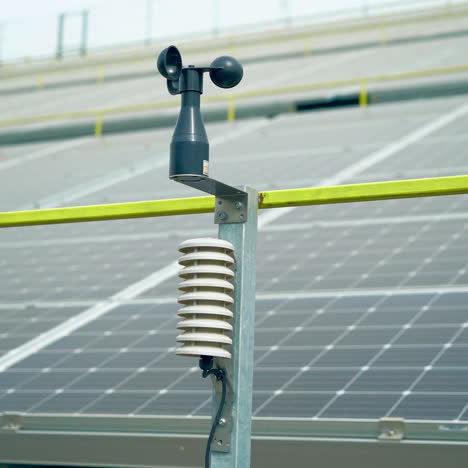 weather station for measuring wind velocity background solar cells. alternative source of electricity. solar farm.
