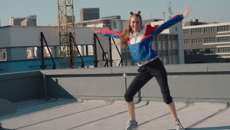 funny woman dancing on rooftop celebrating enjoying silly dance having fun crazy dancer girl in city