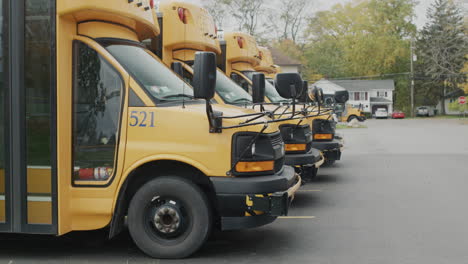 wilson, ny, usa, october 2021: row of yellow school buses in the parking lot near the school