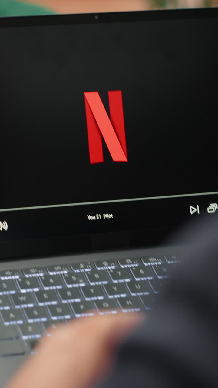 Vertical Video Bucharest, Romania - July 30th 2024 - Young CEO using Netflix to relax in office