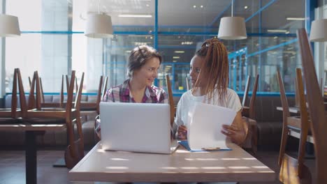 diverse restaurant owners working together on laptop preparing for opening. realtime