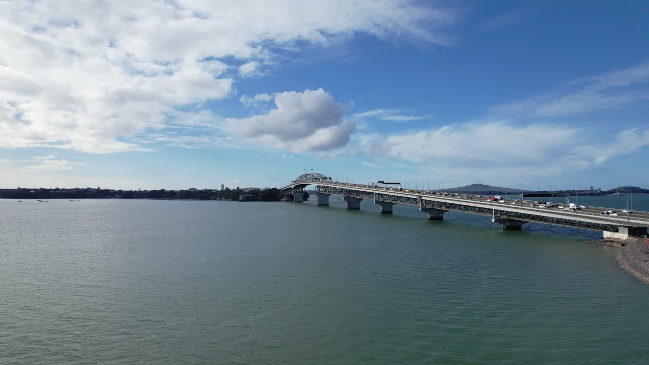 Auckland Harbour Bridge Spanning a Body of Water with Traffic