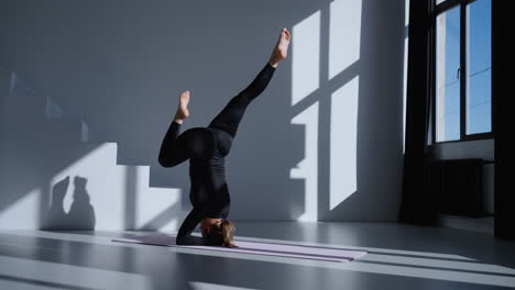 woman practicing yoga pose in a studio