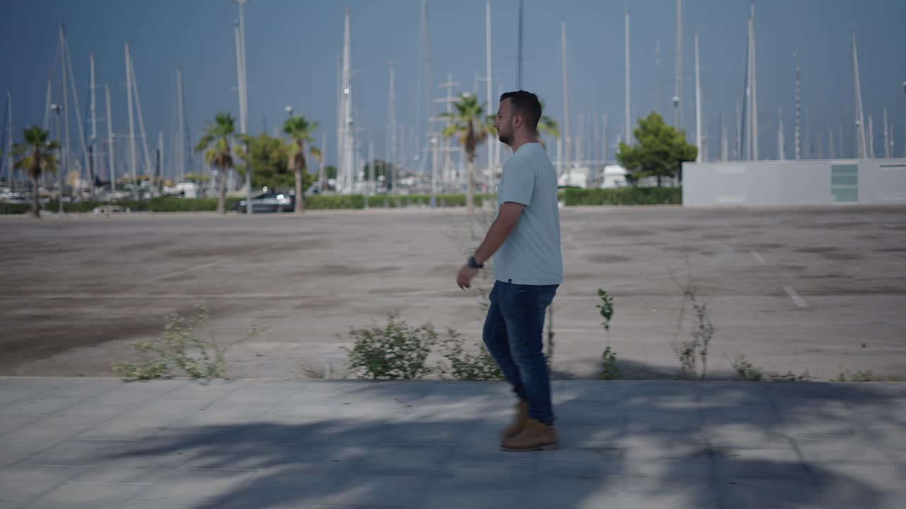 Man Walking in a City Harbor