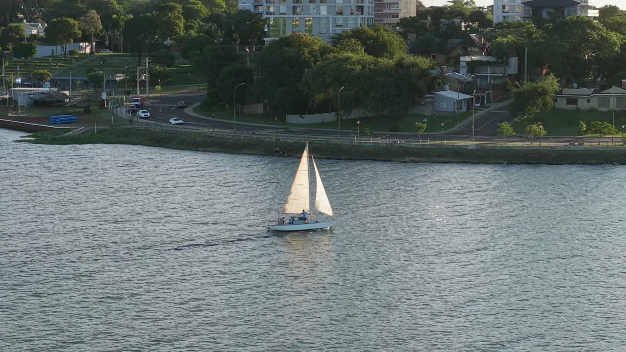 Luxury sailboat cruising at golden hour on Parana River, Argentina, Aerial view