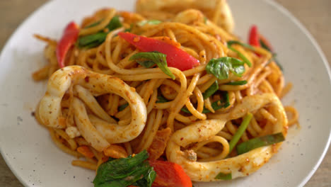 stir-fried spaghetti with salted egg and squid - fusion food style