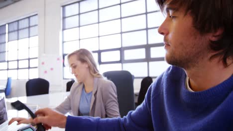 Male-business-executive-talking-on-telephone